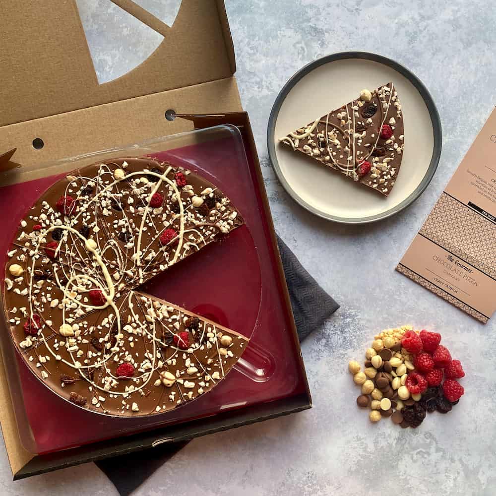Our Crazy Crunch Chocolate Pizzas include a tasty combination of whole and chopped hazelnuts alongside freeze dried raspberries and raisins.